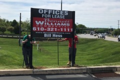 Realtors Standing by Realtor Signs in Philadelphia, PA